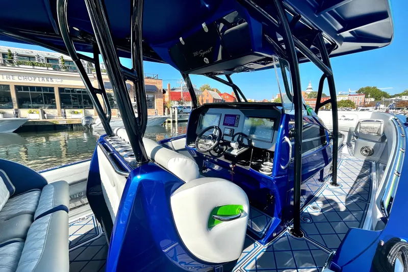 Slide: The Image of 2023 Nor-Tech 390 Sport Center Console boat with sleek blue interior and advanced navigation system. - 2
