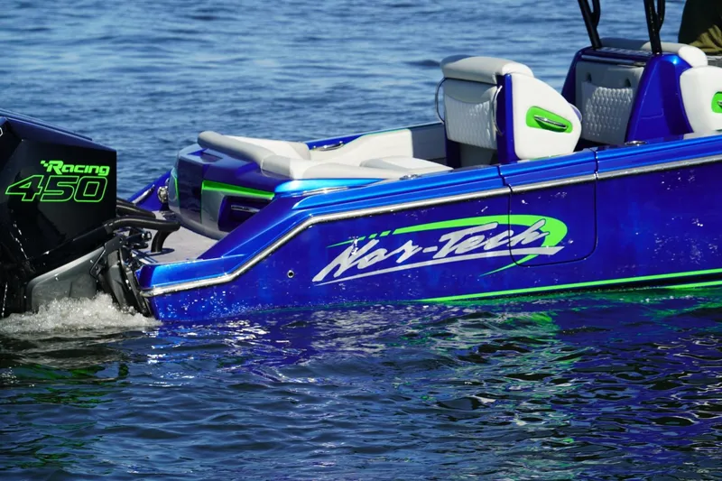 Slide: The Image of 2023 Nor-Tech 390 Sport Center Console boat with Racing 450 engine on water. - 3