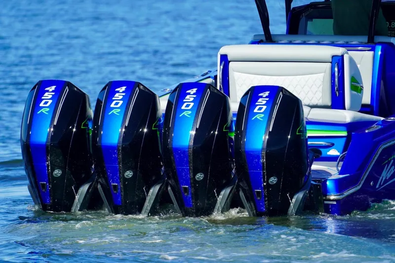 Slide: The Image of 2023 Nor-Tech 390 Sport Center Console with four powerful 450R engines on water. - 4