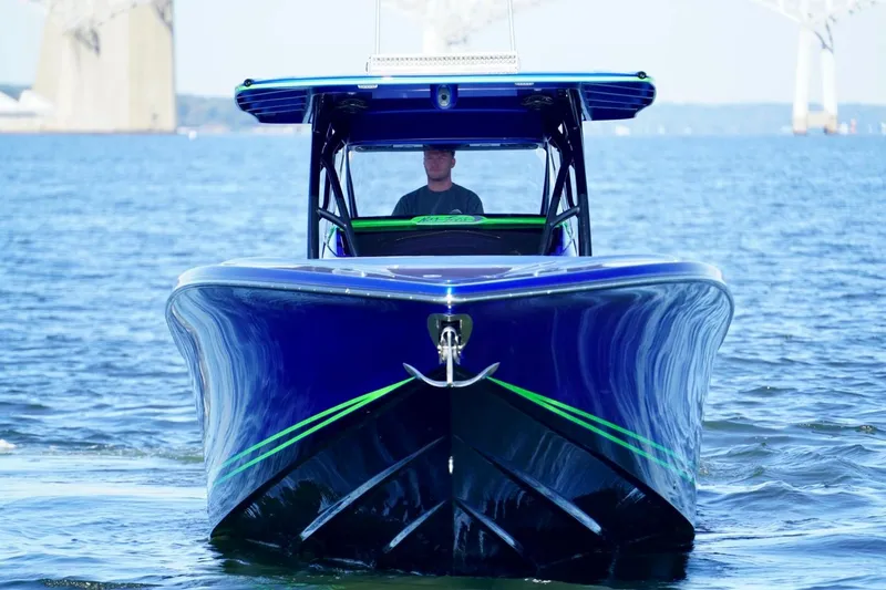 Slide: The Image of 2023 Nor-Tech 390 Sport Center Console boat on water, front view. - 8