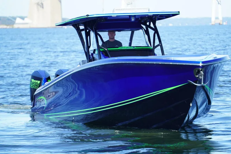 Slide: The Image of 2023 Nor-Tech 390 Sport Center Console boat on water, featuring sleek blue design. - 9