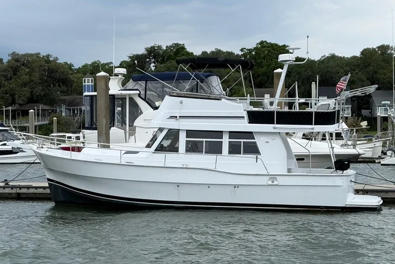 The Image of 1998 Mainship 350 Trawler docked at marina, side view. - 0