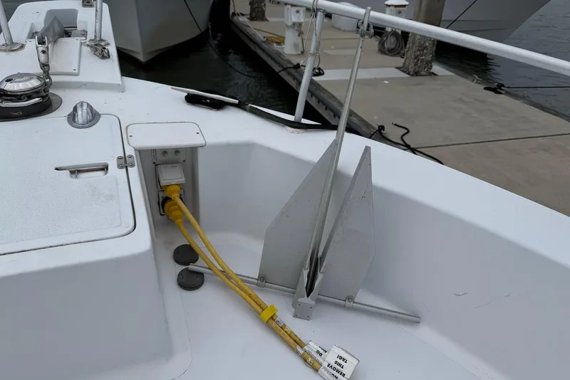 Slide: The Image of 1998 Mainship 350 Trawler deck with anchor and electrical connections at dock. - 10