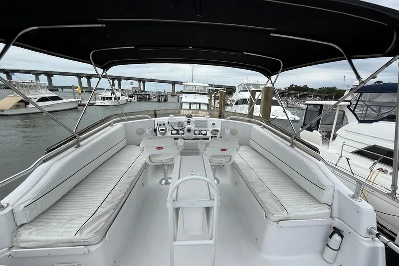 Slide: The Image of 1998 Mainship 350 Trawler interior with seating, docked at marina with bridge view. - 14