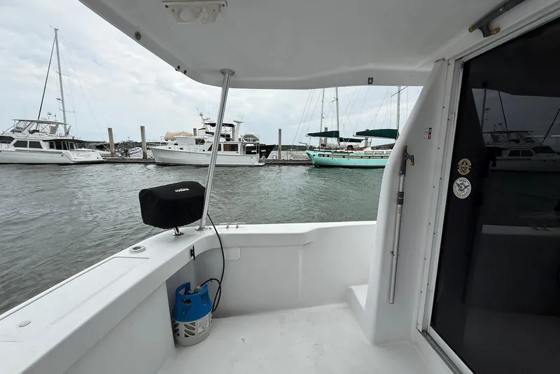Slide: The Image of 1998 Mainship 350 Trawler docked, view from deck with marina background. - 16