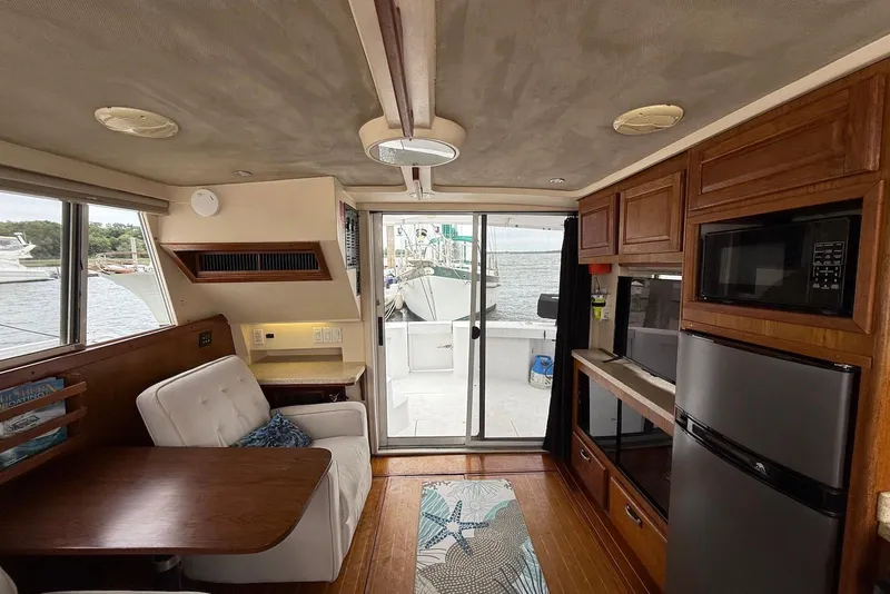 Slide: The Image of Interior of 1998 Mainship 350 Trawler with modern kitchen and cozy seating area. - 19