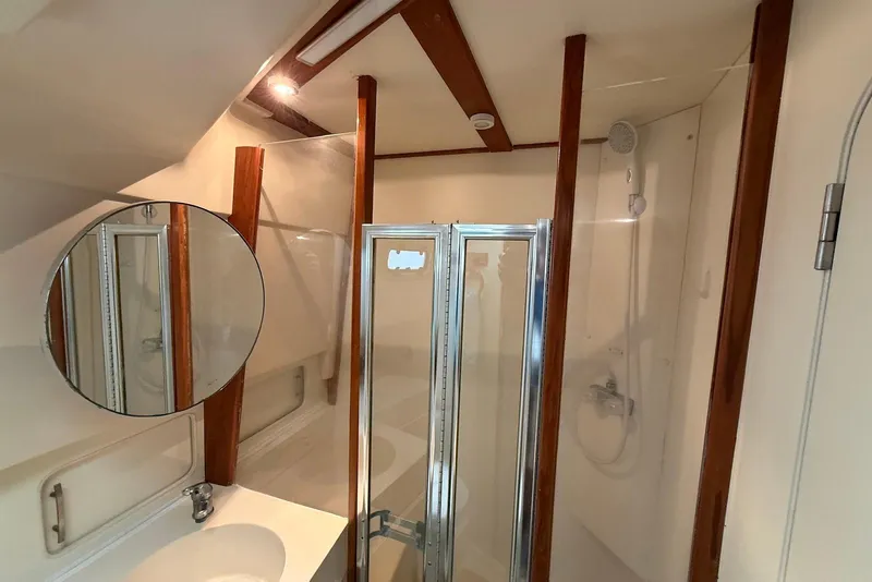 Slide: The Image of Bathroom interior of 1998 Mainship 350 Trawler with shower and mirror. - 33