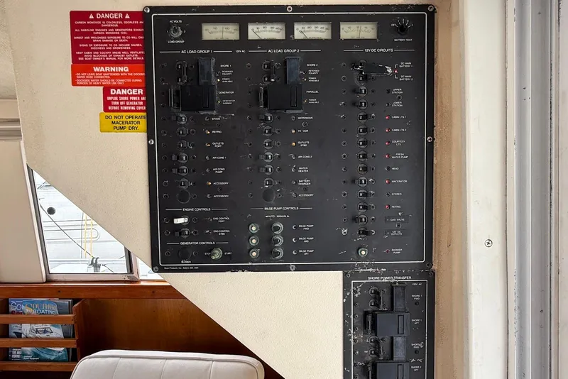 Slide: The Image of Electrical control panel on a 1998 Mainship 350 Trawler boat interior. - 35
