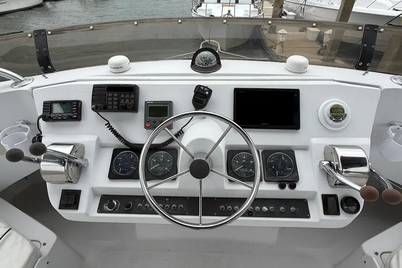 Slide: The Image of Cockpit of 1998 Mainship 350 Trawler with steering wheel and navigation instruments. - 6