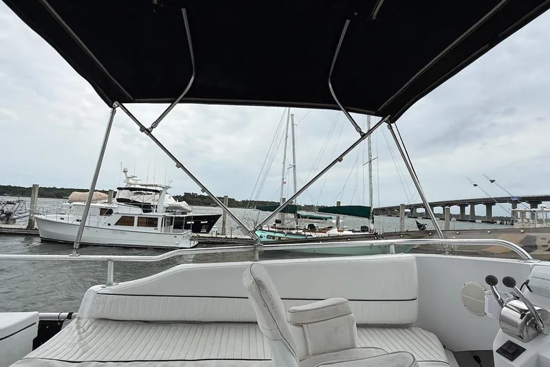 Slide: The Image of 1998 Mainship 350 Trawler interior view at marina, with boats and bridge in background. - 7