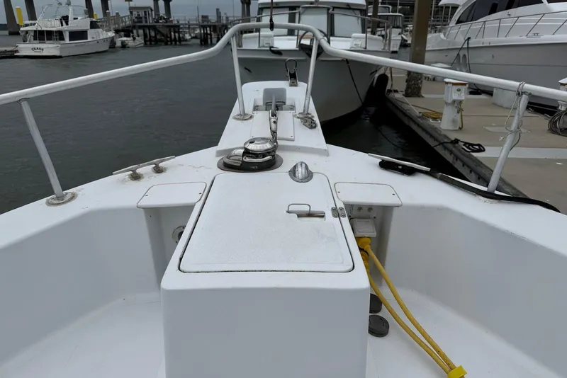Slide: The Image of Bow view of a 1998 Mainship 350 Trawler docked at a marina. - 9