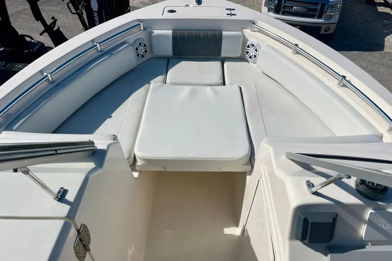 Slide: The Image of 2023 Cobia 220 Dual Console boat interior with cushioned seating and stainless steel railings. - 10