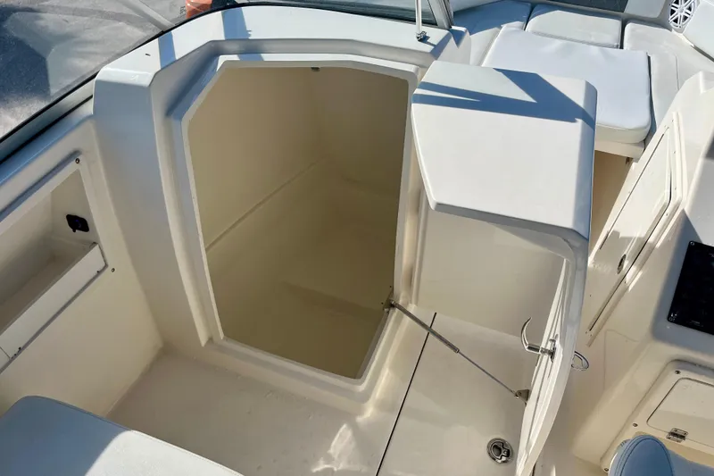 Slide: The Image of 2023 Cobia 220 Dual Console boat interior storage compartment. - 16