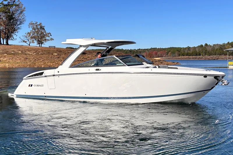 The Image of 2025 Cobalt R33 Surf boat on a tranquil lake. - 0