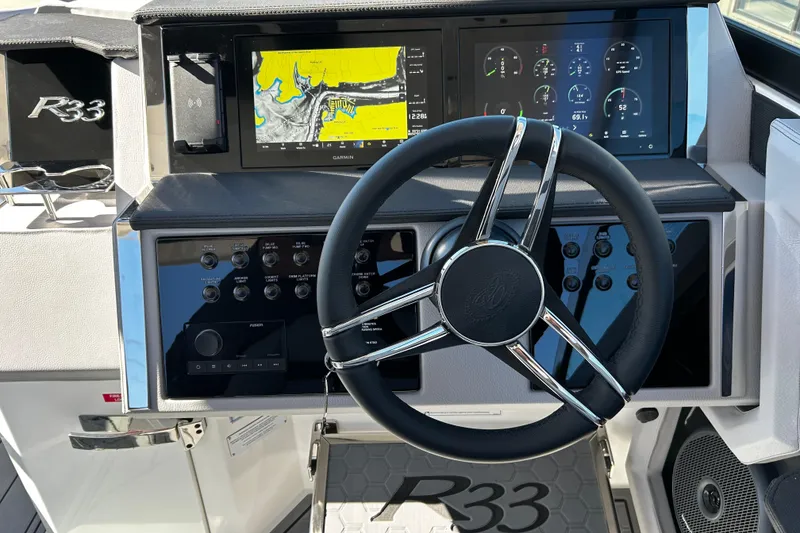 Slide: The Image of Steering wheel and dashboard of 2025 Cobalt R33 Surf boat with digital displays. - 10