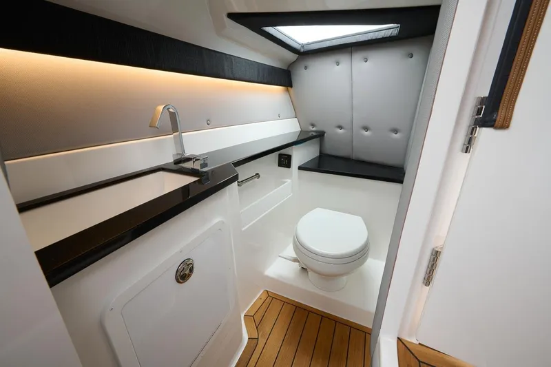 Slide: The Image of Manufacturer Provided Image: Luxurious bathroom in 2025 Cobalt R33 Surf boat with modern fixtures and wood flooring. - 12