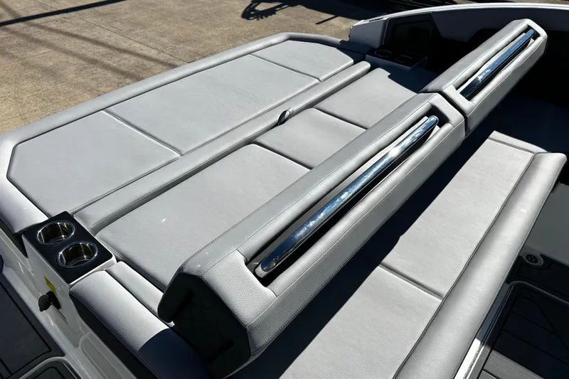 Slide: The Image of 2025 Cobalt R33 Surf boat with sleek gray seating and cup holders. - 16