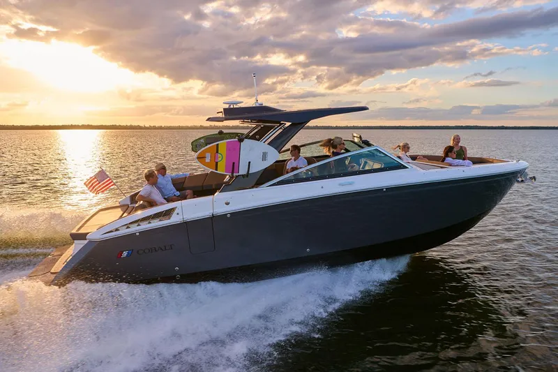 Slide: The Image of Manufacturer Provided Image: 2025 Cobalt R33 Surf boat cruising on a lake at sunset with passengers onboard. - 19
