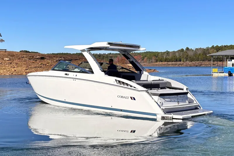Slide: The Image of Cobalt R33 Surf 2025 on a serene lake under sunny skies. - 2