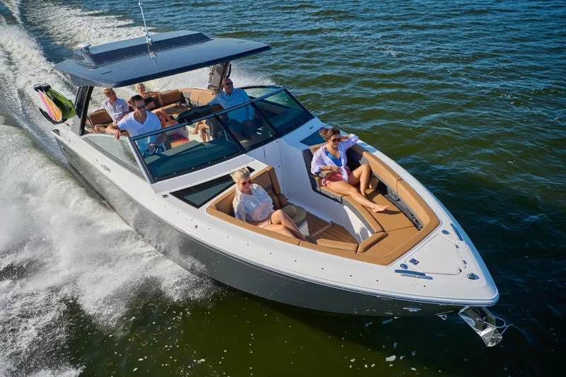 Slide: The Image of Manufacturer Provided Image: 2025 Cobalt R33 Surf boat cruising with passengers on a sunny day. - 22