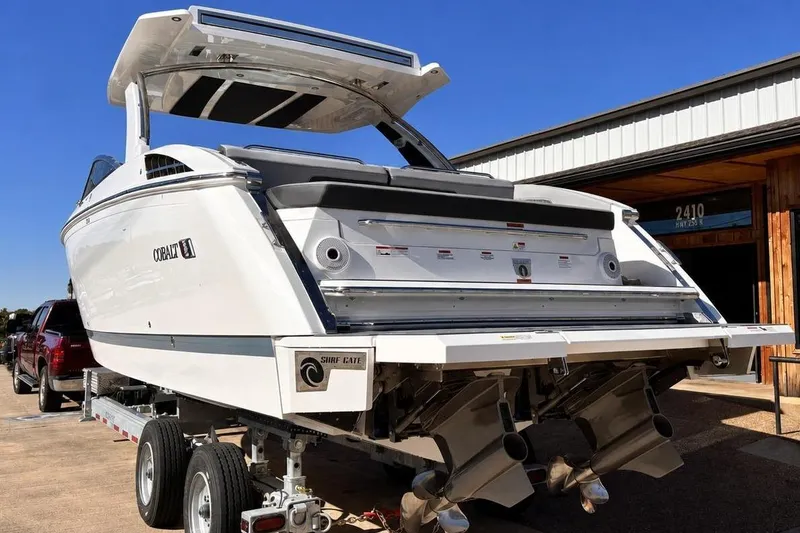Slide: The Image of 2025 Cobalt R33 Surf boat on trailer, rear view. - 5