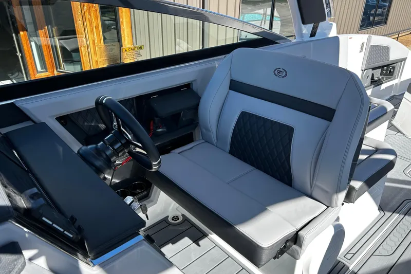 Slide: The Image of 2025 Cobalt R33 Surf boat interior with steering wheel and luxurious seating. - 9