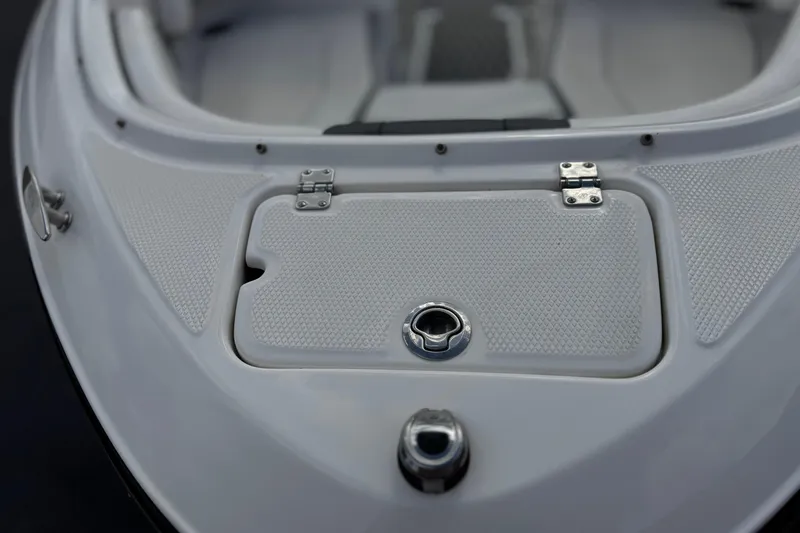 Slide: The Image of 2020 Chaparral 21 Surf boat deck with textured surface and storage compartment. - 11