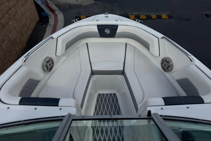 Slide: The Image of 2020 Chaparral 21 Surf boat interior with cushioned seating and built-in speakers. - 13