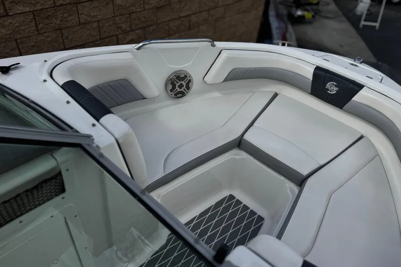 Slide: The Image of 2020 Chaparral 21 Surf boat interior with white cushioned seating and speaker detail. - 14