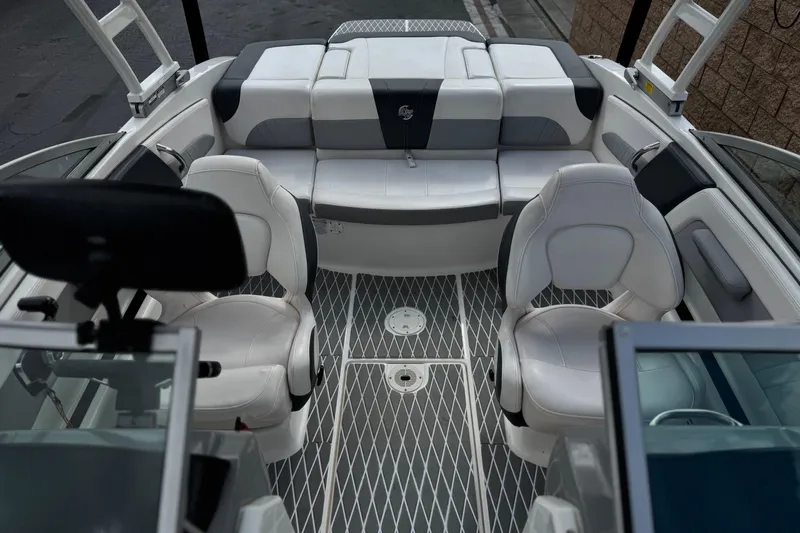 Slide: The Image of 2020 Chaparral 21 Surf boat interior with white seating and modern design. - 16