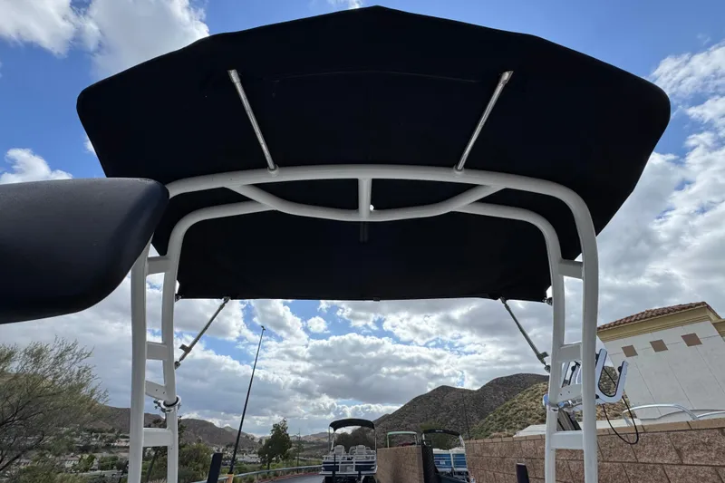 Slide: The Image of 2020 Chaparral 21 Surf boat canopy against a cloudy sky backdrop. - 17
