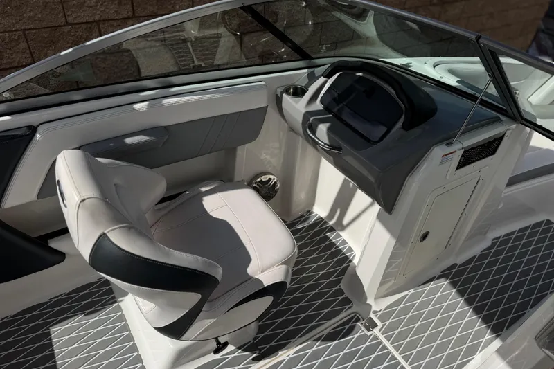 Slide: The Image of Interior of 2020 Chaparral 21 Surf boat, featuring sleek helm and comfortable seating. - 23