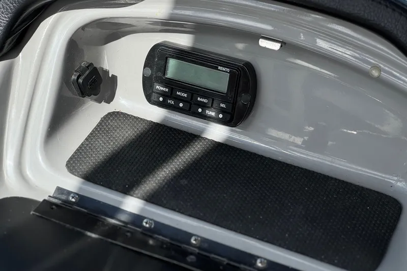 Slide: The Image of Control panel of a 2020 Chaparral 21 Surf boat, featuring a digital display. - 24