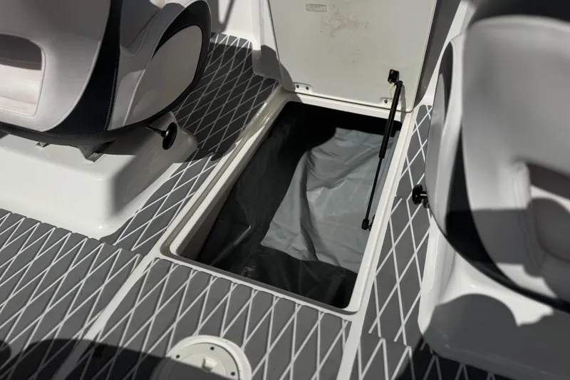 Slide: The Image of 2020 Chaparral 21 Surf boat interior storage compartment with open hatch and seating. - 28