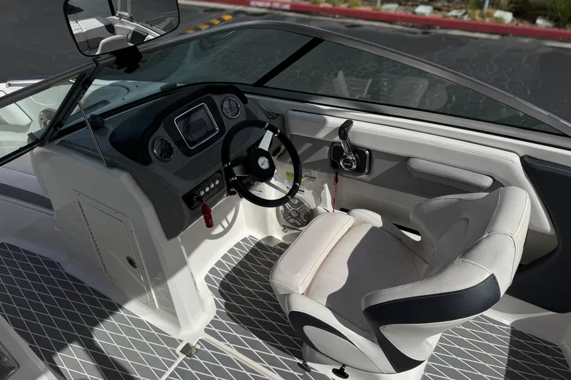 Slide: The Image of 2020 Chaparral 21 Surf boat interior with steering wheel and dashboard controls. - 29