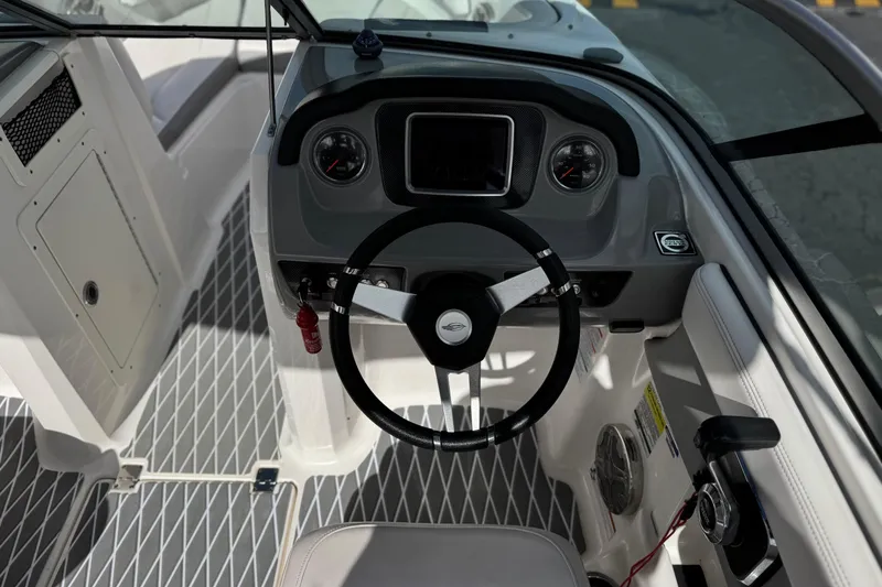 Slide: The Image of 2020 Chaparral 21 Surf boat cockpit with steering wheel and dashboard controls. - 30