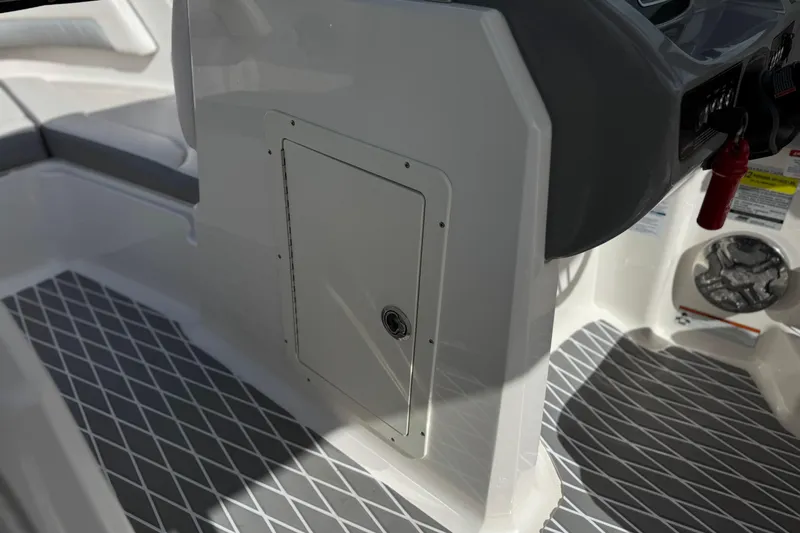 Slide: The Image of 2020 Chaparral 21 Surf boat interior with storage compartment and textured flooring. - 31