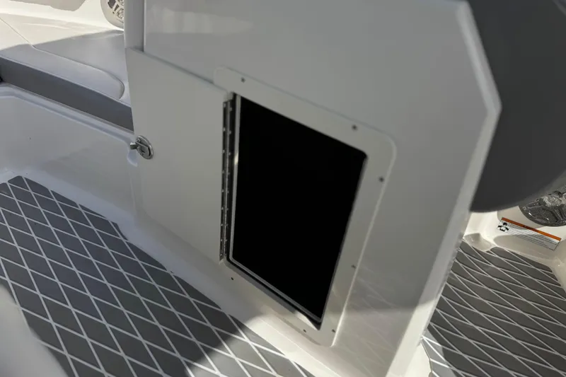 Slide: The Image of 2020 Chaparral 21 Surf boat interior with open storage compartment and diamond-patterned flooring. - 32