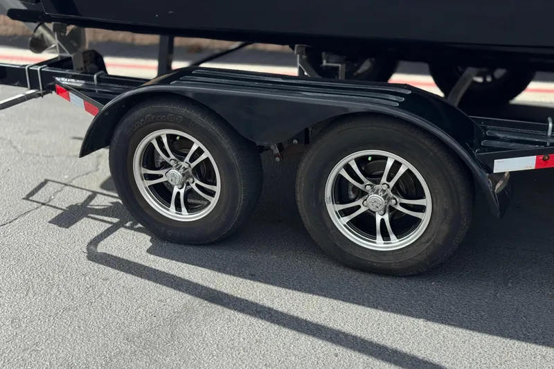 Slide: The Image of Trailer wheels of a 2020 Chaparral 21 Surf boat on pavement. - 33