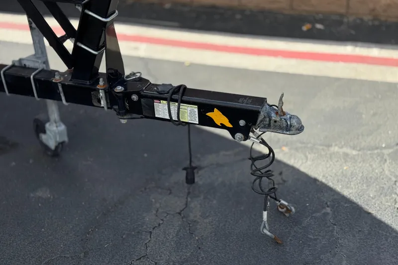 Slide: The Image of Trailer hitch of a 2020 Chaparral 21 Surf boat on pavement. - 34