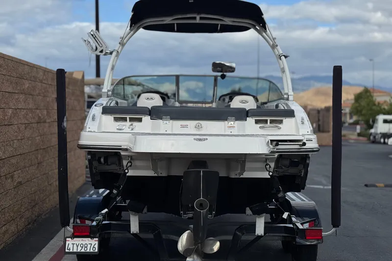 Slide: The Image of 2020 Chaparral 21 Surf boat on trailer, rear view, parked outdoors. - 4
