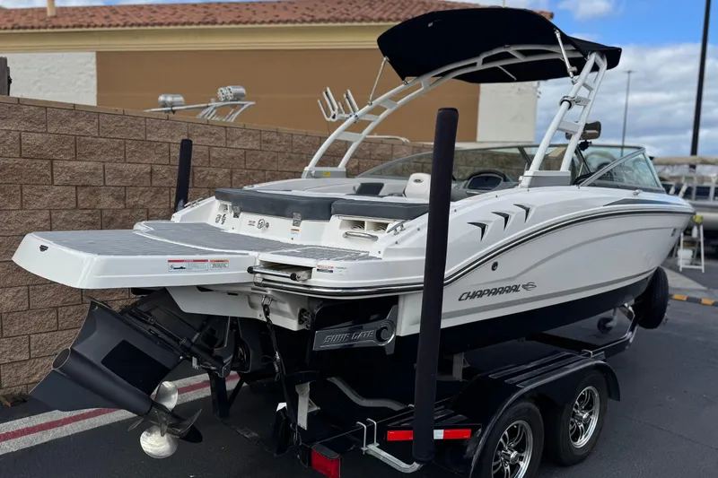 Slide: The Image of 2020 Chaparral 21 Surf boat on trailer, featuring sleek design and powerful engine. - 5