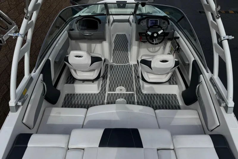 Slide: The Image of 2020 Chaparral 21 Surf boat interior with modern seating and sleek dashboard design. - 9