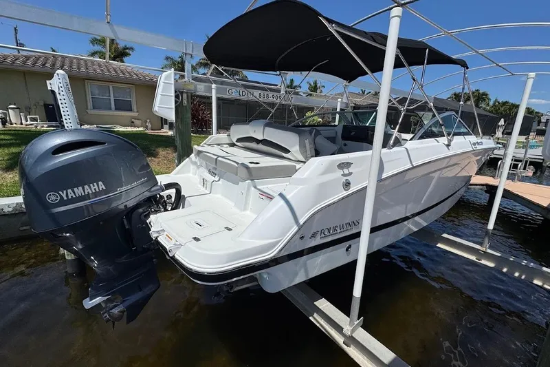 Slide: The Image of 2020 Four Winns HD220 OB boat with Yamaha outboard motor on a lift. - 10