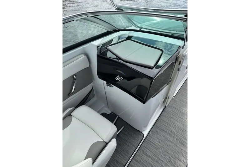 Slide: The Image of 2020 Four Winns HD220 OB boat interior with seating and storage compartment. - 14