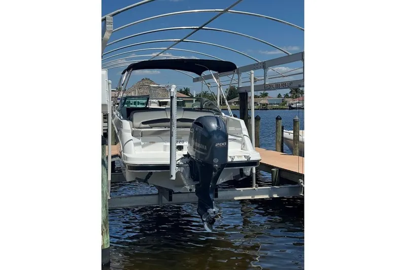 Slide: The Image of 2020 Four Winns HD220 OB boat docked with Yamaha outboard motor. - 6