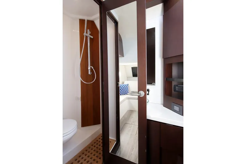 Slide: The Image of Manufacturer Provided Image: Modern bathroom interior on Jupiter 43 yacht, featuring shower and sleek wooden finishes, 2026 model. - 10