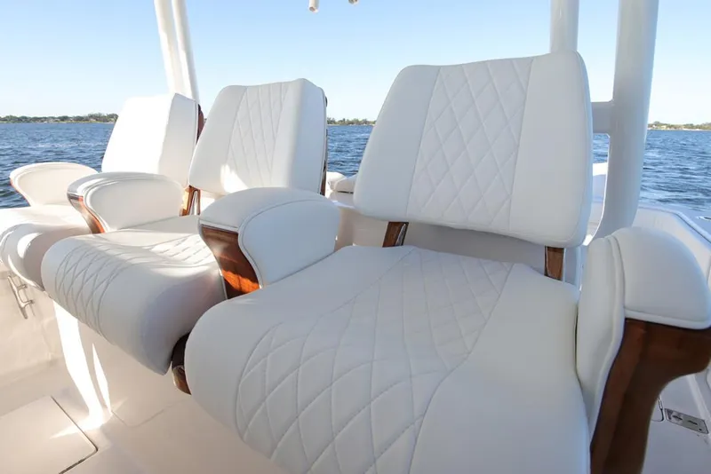 Slide: The Image of Manufacturer Provided Image: Luxurious white seating on a 2026 Jupiter 43 boat, with ocean view in the background. - 6