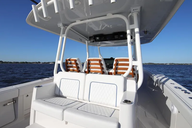 Slide: The Image of Manufacturer Provided Image: 2026 Jupiter 43 boat interior with cushioned seating, ocean view, and sleek design. - 7