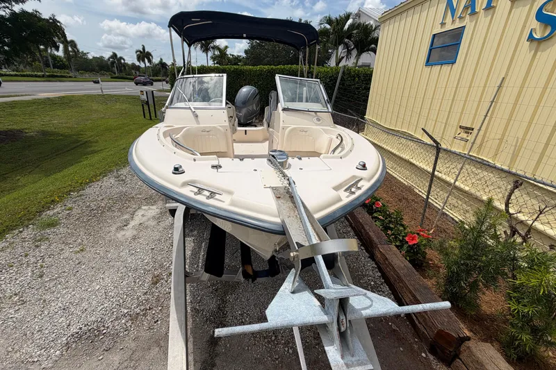 Slide: The Image of 2006 Grady-White Tournament 185 boat on trailer, parked outdoors near a building. - 2